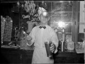 Soda_jerker_flipping_ice_cream_into_malted_milk_shakes._Corpus_Christi,_Texas
